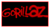 a stamp with a small red border with a black background, the words GORILLAZ are spraypainted on in a medium red color