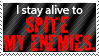 a stamp with a dark striped background, going between a dark gray and a medium gray. the text starts off white, saying I stay alive to, and then the text is big in bold red, finishing the sentence with spite my enemies.